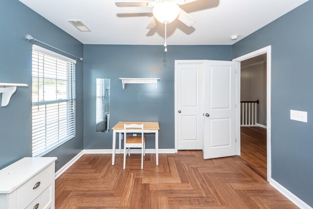 interior space with a ceiling fan, visible vents, and baseboards