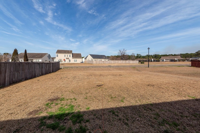 view of yard featuring a residential view and fence