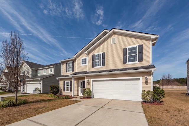 traditional-style home with driveway, an attached garage, and a front yard