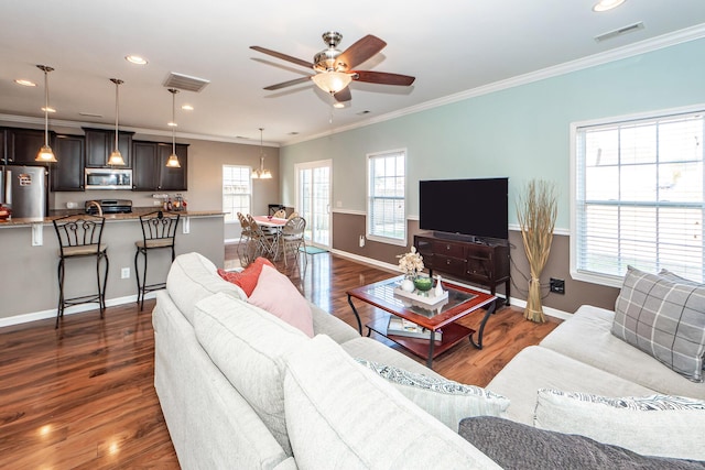 living room featuring crown molding, dark wood finished floors, visible vents, ceiling fan, and baseboards