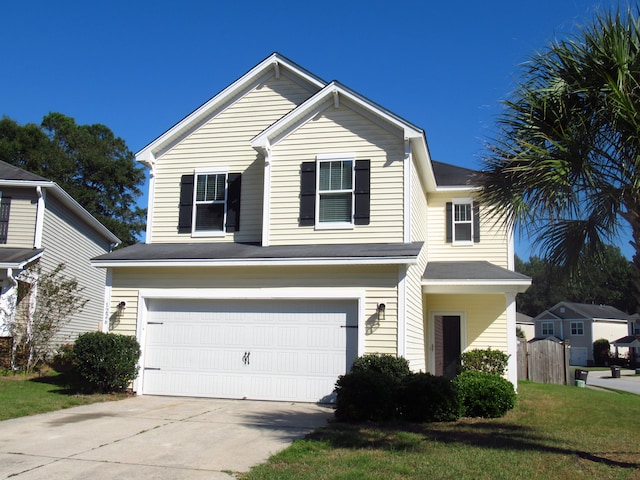 front of property featuring a front yard and a garage