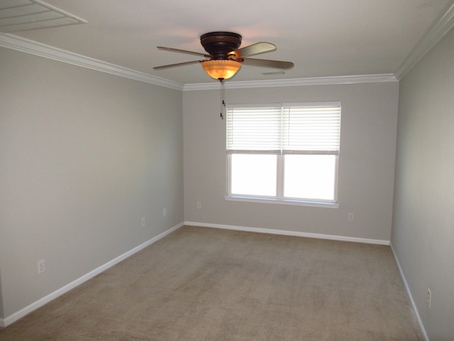 empty room with ceiling fan, light colored carpet, and crown molding