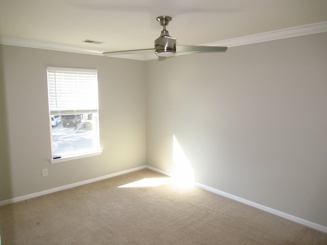 spare room featuring ceiling fan, ornamental molding, and carpet