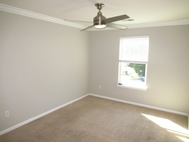 empty room with ceiling fan, crown molding, and carpet flooring