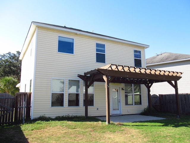 rear view of property with a pergola, a patio area, and a lawn