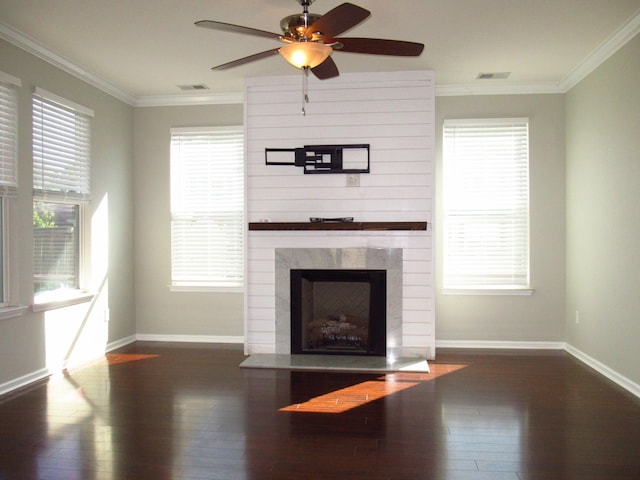 unfurnished living room featuring ceiling fan, crown molding, dark hardwood / wood-style floors, and a high end fireplace