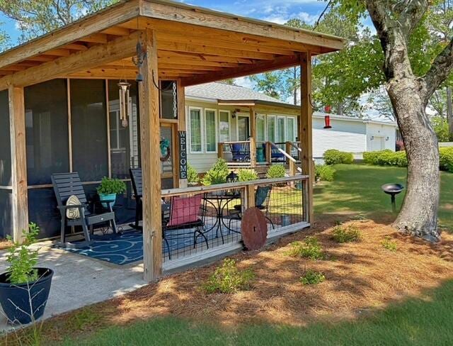 view of patio with a sunroom