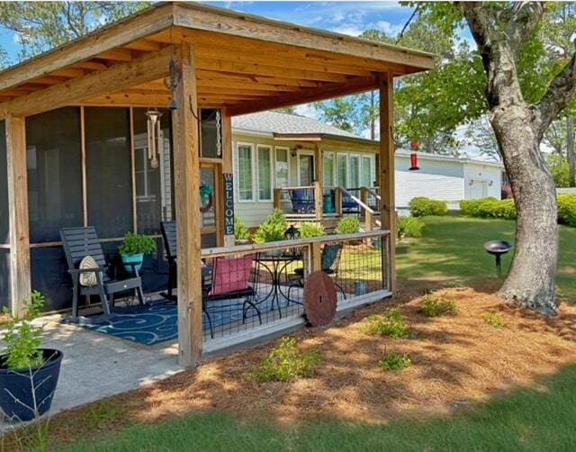 view of patio / terrace featuring a sunroom