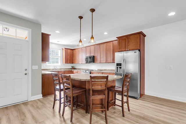 350 Cypress Walk Way, Wando, SC 29492 - kitchen featuring stainless steel appliances, light wood-style floors, a kitchen island, a kitchen breakfast bar, and recessed lighting