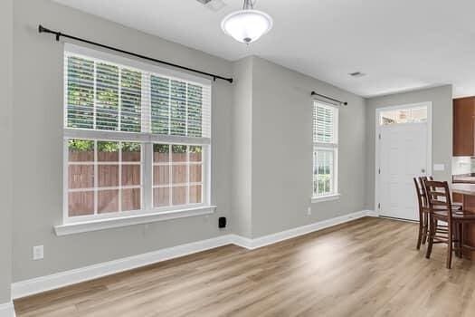 350 Cypress Walk Way, Wando, SC 29492 - unfurnished dining area with light wood-type flooring and baseboards