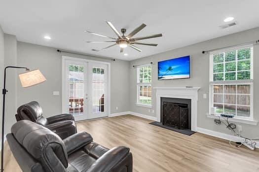 350 Cypress Walk Way, Wando, SC 29492 - living room with wood finished floors, ceiling fan, french doors, a fireplace, and recessed lighting