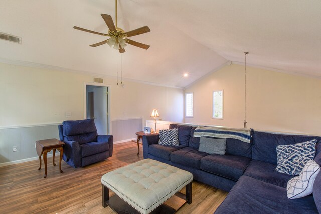 living room featuring crown molding, lofted ceiling, hardwood / wood-style floors, and ceiling fan