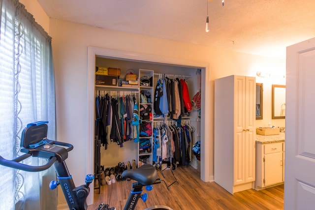 exercise room featuring a textured ceiling and hardwood / wood-style flooring