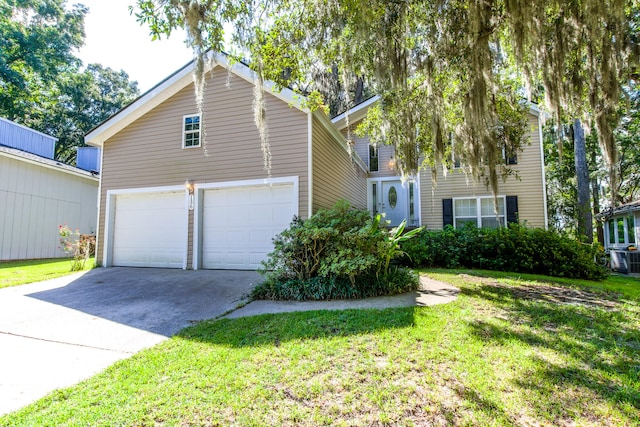 view of front of property with a garage, central AC unit, and a front yard