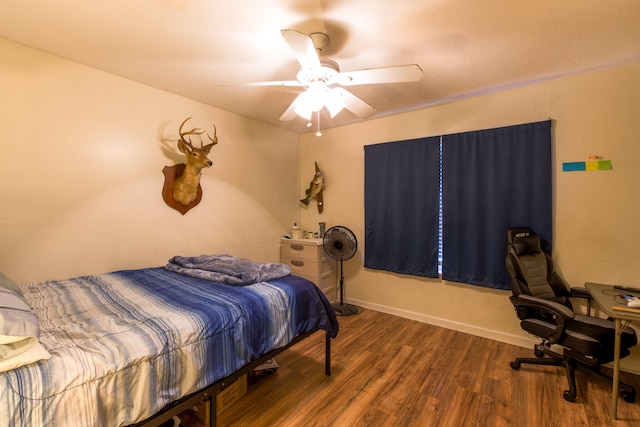 bedroom featuring ceiling fan and dark hardwood / wood-style flooring