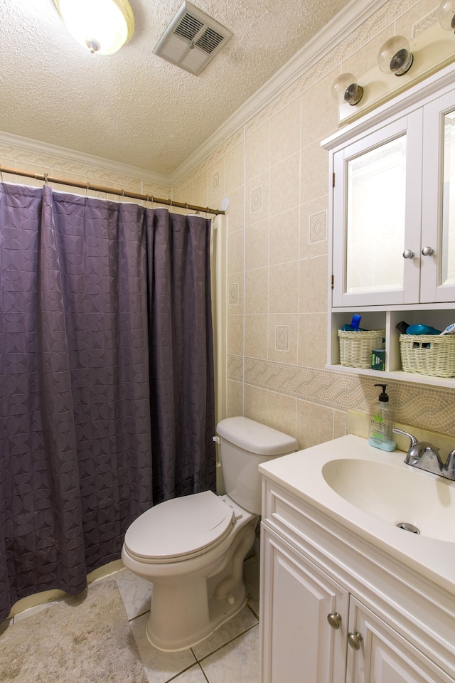 bathroom featuring toilet, crown molding, vanity, a textured ceiling, and tile walls