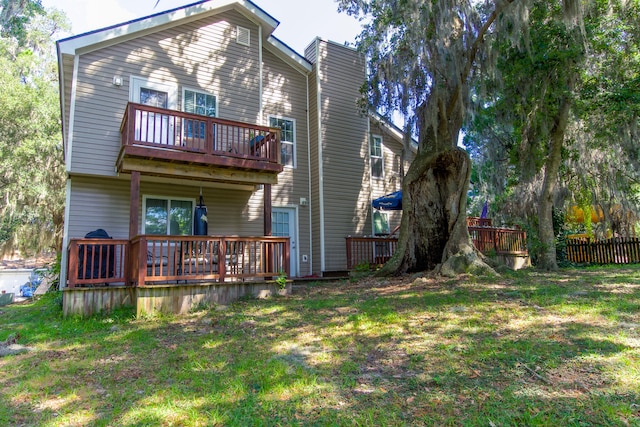 back of house with a yard and a deck