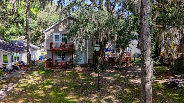 back of house with a deck