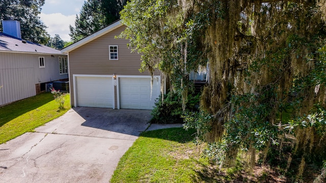 exterior space featuring a garage and a front lawn