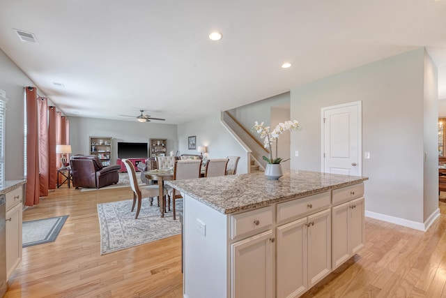 109 Cypress Plantation Rd, Moncks Corner, SC 29461 - kitchen with ceiling fan, light wood-style floors, light stone countertops, a center island, and recessed lighting