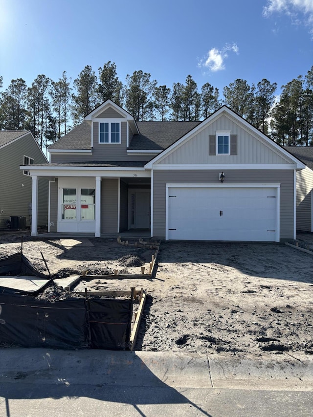 view of front facade featuring an attached garage and dirt driveway