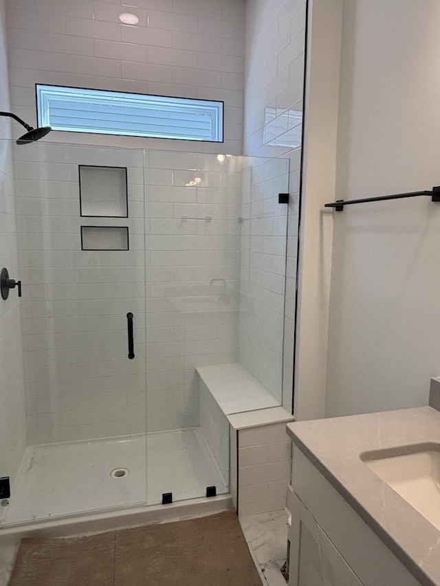 bathroom featuring a stall shower and vanity