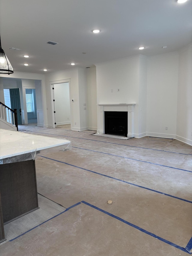 unfurnished living room with baseboards, a fireplace, visible vents, and recessed lighting