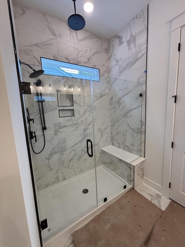 full bathroom featuring marble finish floor and a marble finish shower