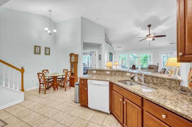 kitchen with ceiling fan with notable chandelier, a healthy amount of sunlight, white dishwasher, and sink