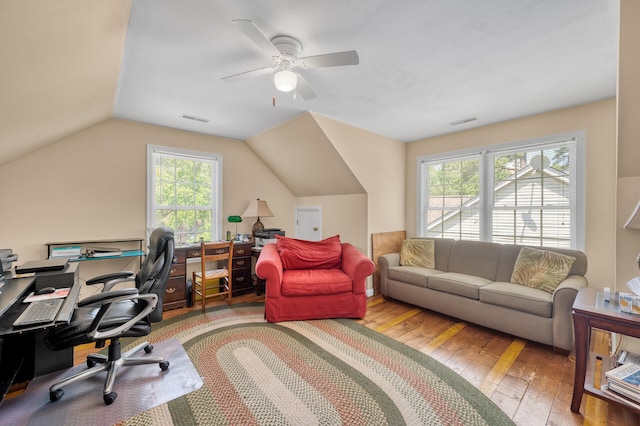 home office with lofted ceiling, hardwood / wood-style floors, ceiling fan, and a healthy amount of sunlight