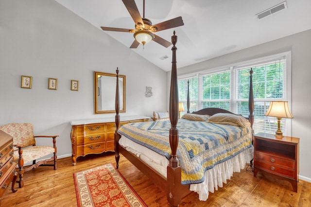 bedroom with visible vents, ceiling fan, vaulted ceiling, wood finished floors, and baseboards