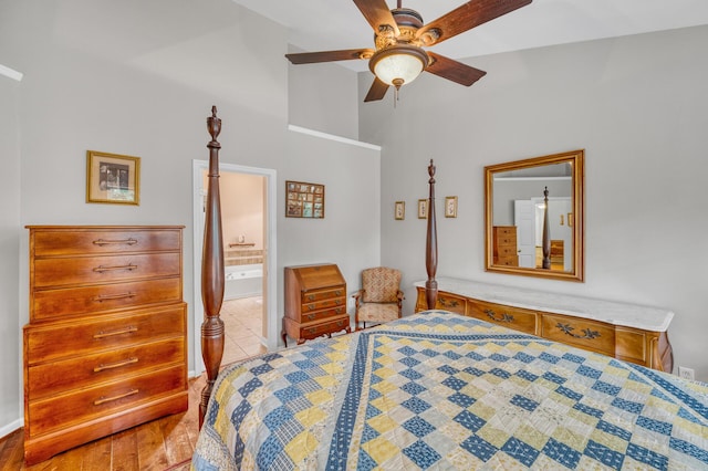 bedroom featuring light tile patterned flooring, ceiling fan, and ensuite bath