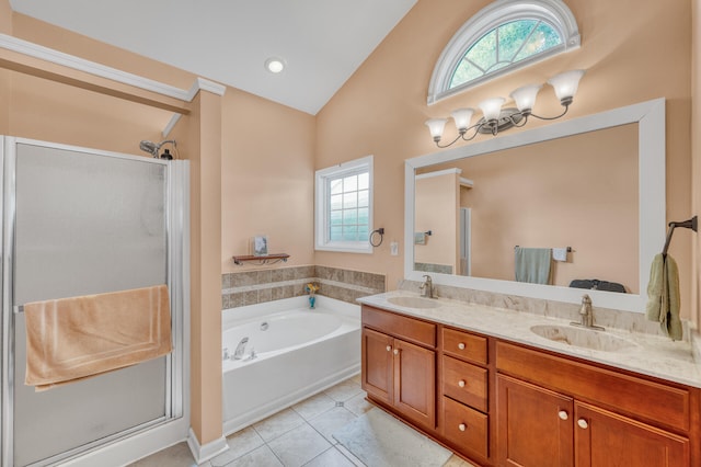 bathroom with plus walk in shower, tile patterned flooring, lofted ceiling, and vanity