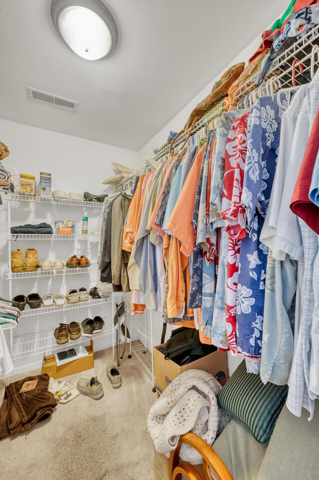 walk in closet with visible vents and carpet flooring