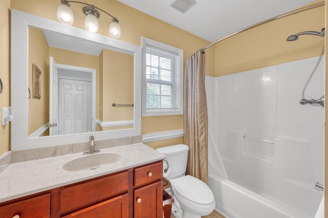 full bathroom with shower / tub combo, visible vents, vanity, and toilet