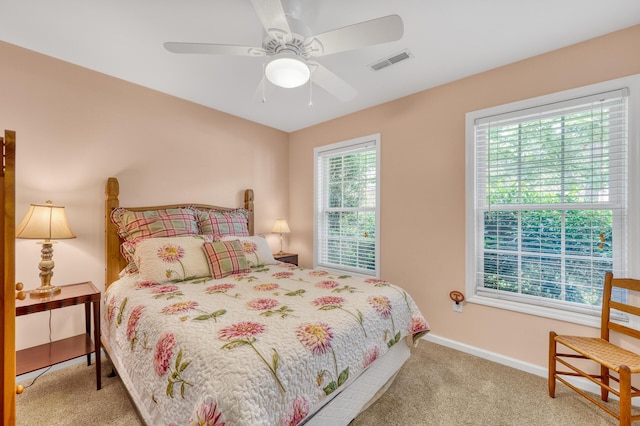 bedroom featuring ceiling fan, carpet flooring, visible vents, and baseboards