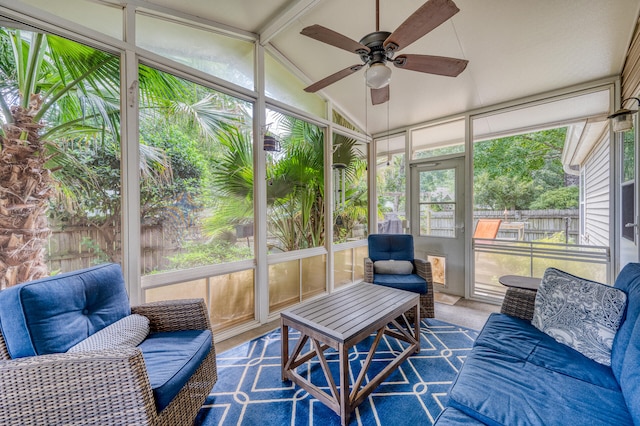 sunroom featuring lofted ceiling and ceiling fan