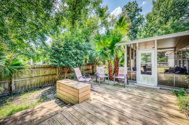 deck featuring a fire pit and a sunroom