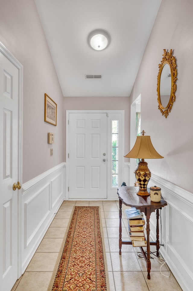 tiled entryway with lofted ceiling