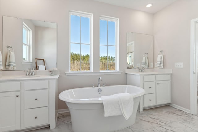 782 Clay Field Trl, Summerville, SC 29485 - full bathroom featuring a sink, marble finish floor, a freestanding bath, two vanities, and baseboards