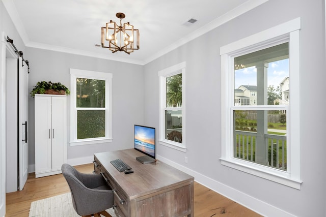 home office featuring light wood-type flooring, a barn door, crown molding, and an inviting chandelier