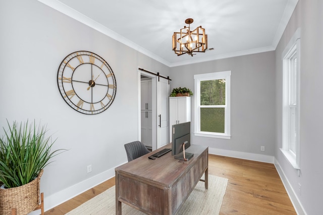 office area featuring a barn door, an inviting chandelier, light wood-type flooring, and ornamental molding