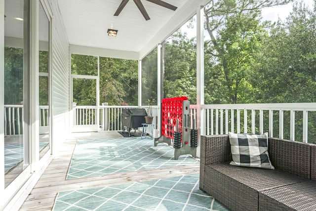 sunroom featuring ceiling fan