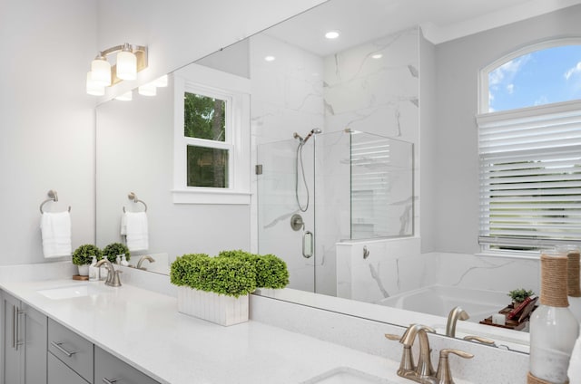 bathroom with independent shower and bath and vanity