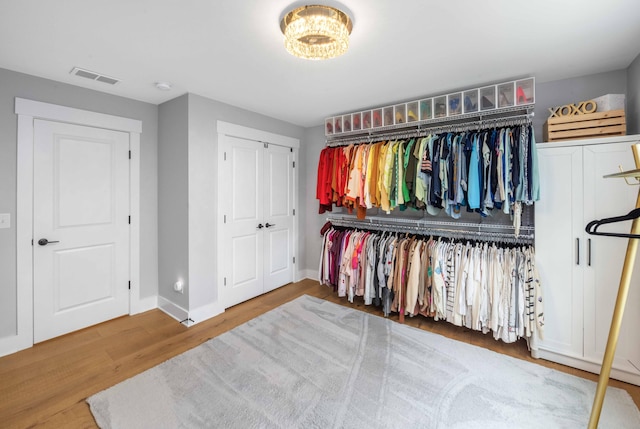 spacious closet featuring hardwood / wood-style flooring