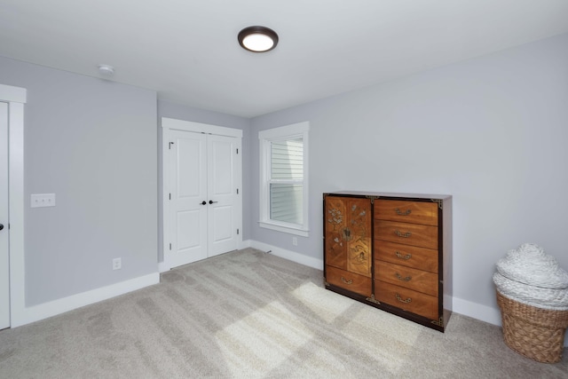 bedroom with a closet and light colored carpet