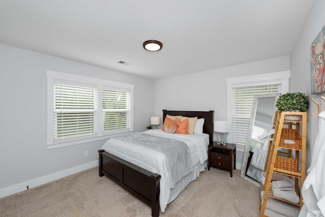 bedroom featuring light carpet