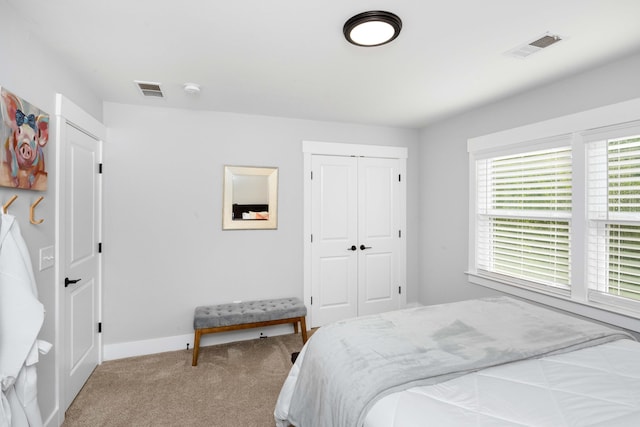 carpeted bedroom featuring a closet