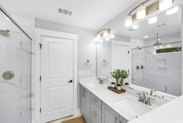 bathroom with vanity and a shower with shower door