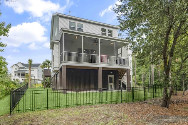 rear view of house featuring a sunroom, a yard, and ceiling fan